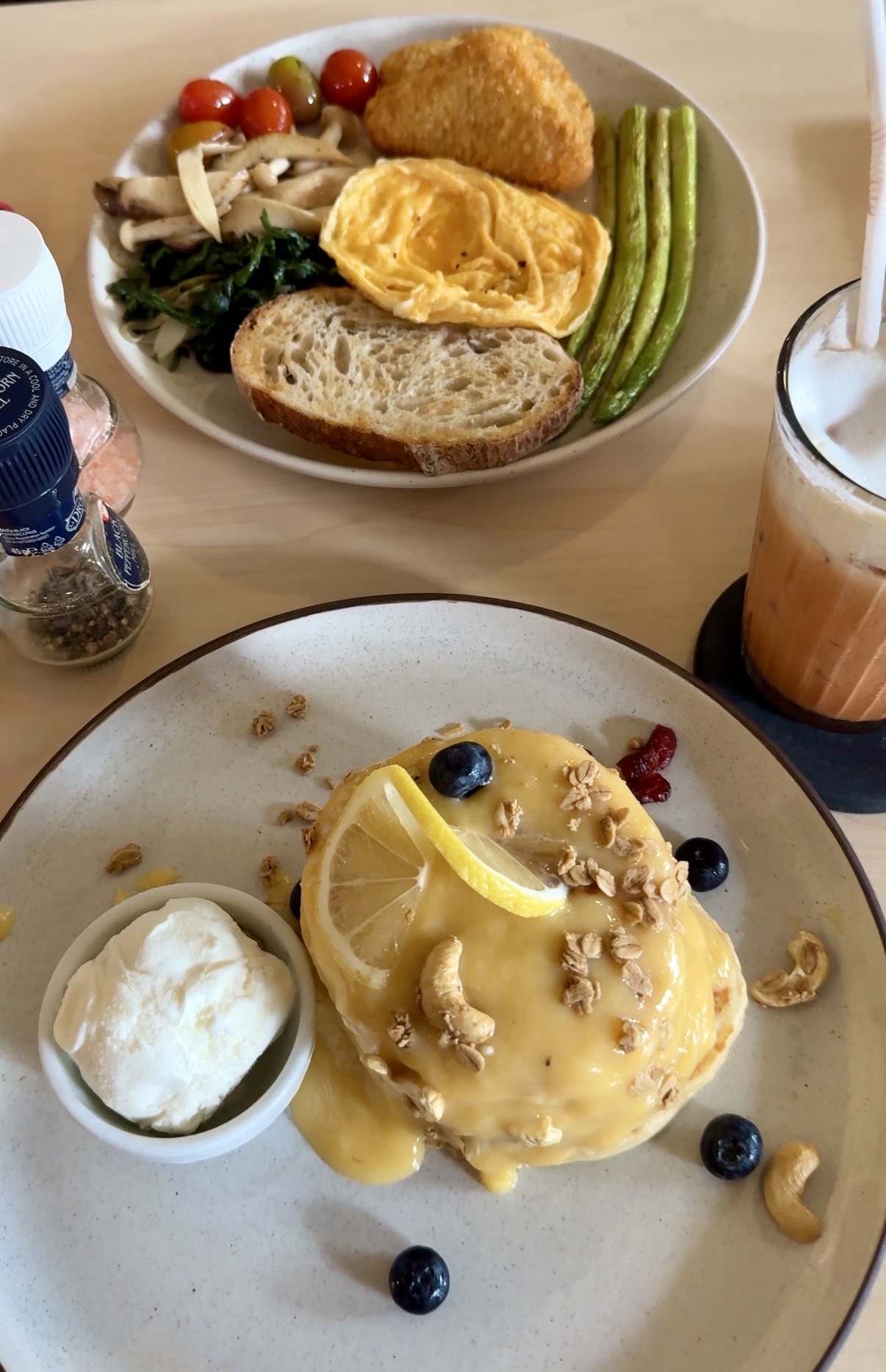 Lemon pancakes with fresh fruit and iced coffee at The Verandah Café in Ao Nang, Thailand