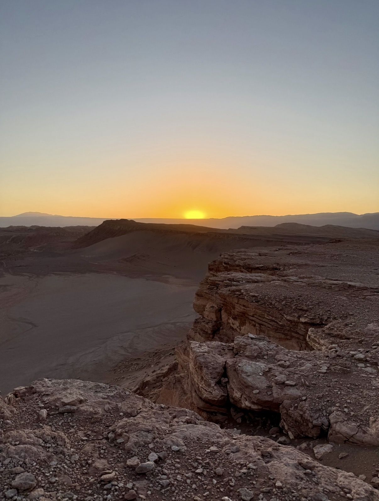 Sunset over the cliffs and desert basin near Valle de la Luna in the Atacama Desert, Chile.