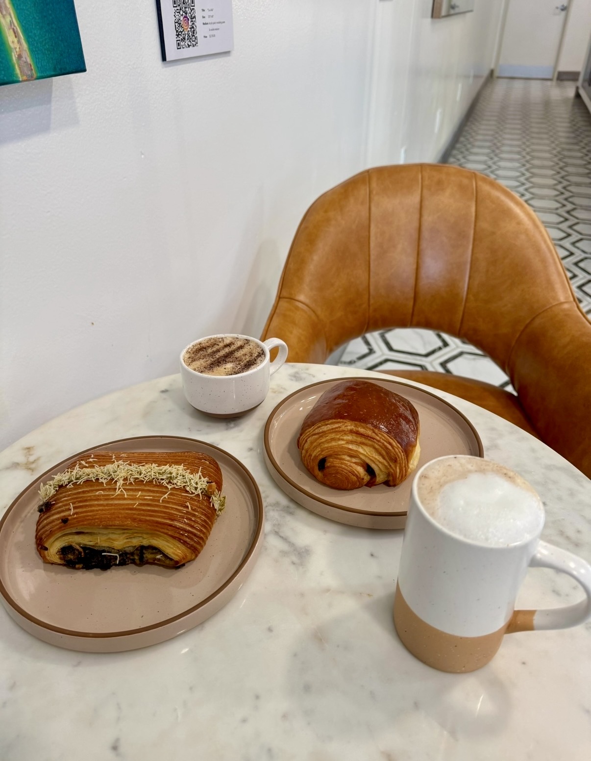 Pastries and coffee drinks on a marble table in San Diego
