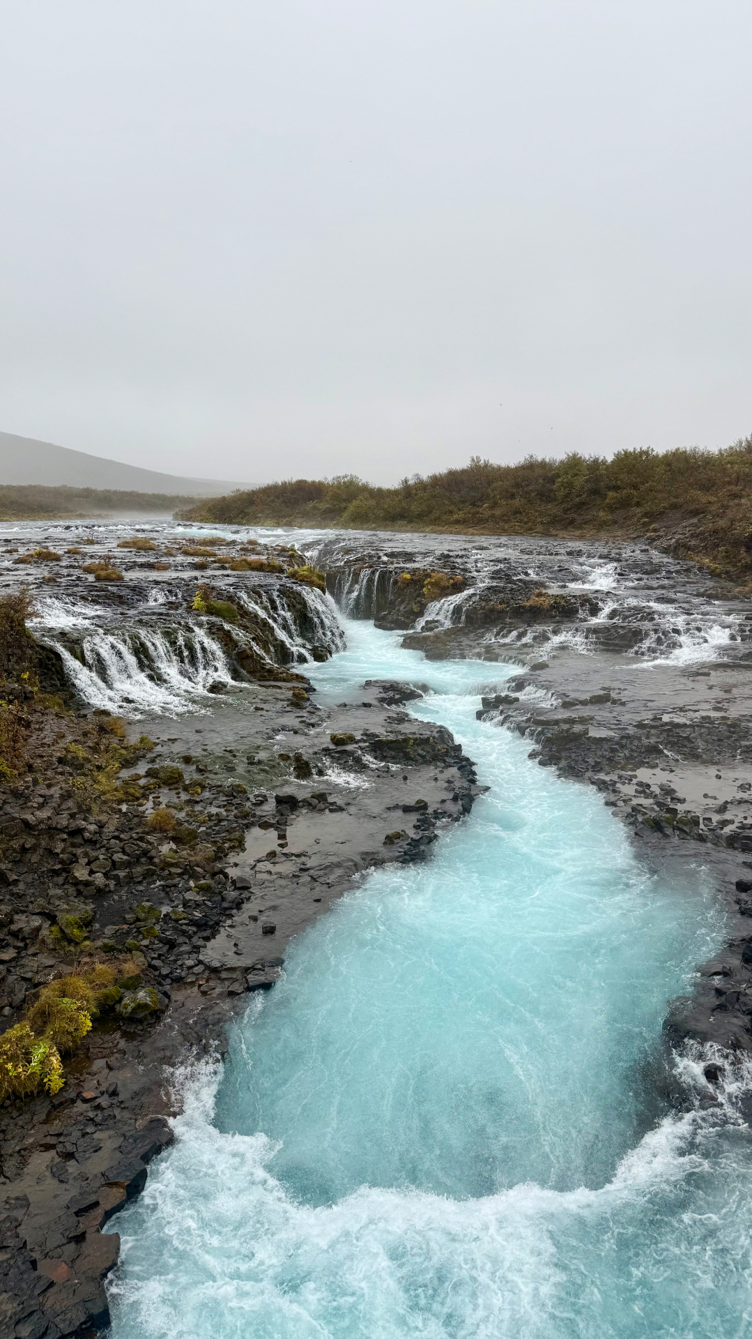 Bright blue water at Brúarfoss waterfall in Iceland